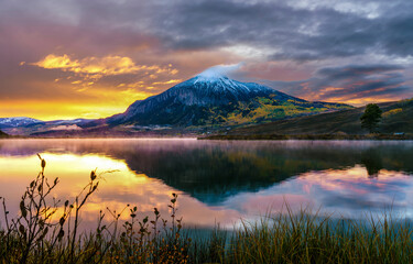 Sunset over mountain lake. Mountain lake at sunset