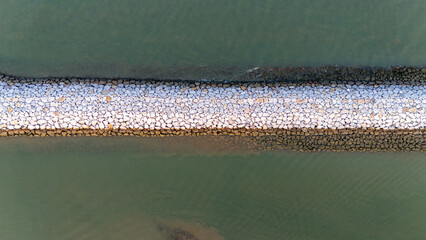 Aerial view of Beautiful rock breakwater in Thailand.