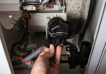 The rubber drain pipe and drain pump are clogged with clothes in the washing machine. Cleaning the...