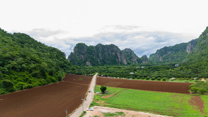 Aerial view of the Agricultural field, mountain, road, and city.