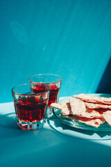 Biblical communion with wine and bread on blue background, christian religion vertical card