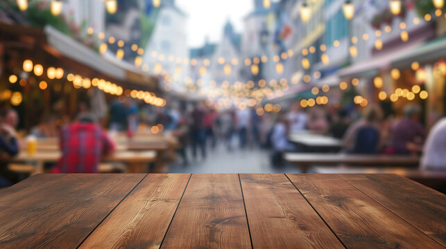 close up of empty wooden table with blurred people celebrate oktoberfest background