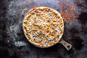 Funghi pizza served in wooden board isolated on dark background top view of italian fastfood