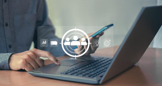 Business marketing position concept, businessman holds dart board icon with arrows for customer target group.	