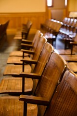 vintage wood armchairs in the spectator seating area of the courtroom
