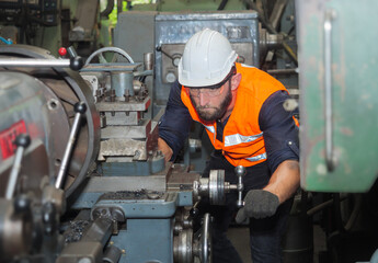 Portrait of Confident factory workers are customizing machines in preparation for the production of...