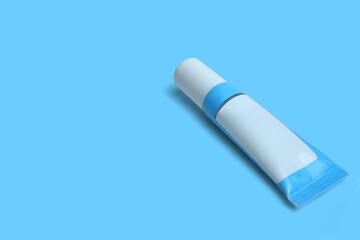 blue plastic skincare cream tube isolated on blue background. Clipping path.