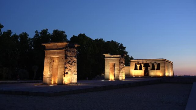 The Ancient Temple of Debod in Madrid, Spain at Sunset. Lit Up. Egyptian Monument in Europe. Tourist Destination Famous Landmark at Dusk.