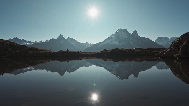 French Alps landscape of Lac des Cheserys with Mont Blanc massif and trail runner reflection at France