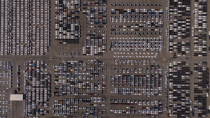 Top view of the electric vehicle transport yard and intercontinental shipping industry..