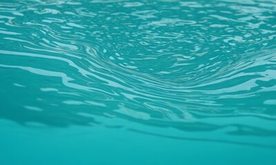 Fototapeta premium close-up view of a body of water, possibly a pool or a lake, with a swirling pattern of light blue-green water.