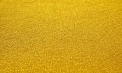 Fototapeta premium close-up of a yellow fabric with a textured surface.