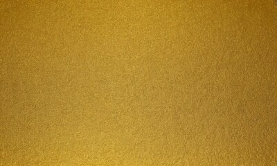 Fototapeta premium close-up of a textured surface with a golden color, possibly a piece of paper or fabric.