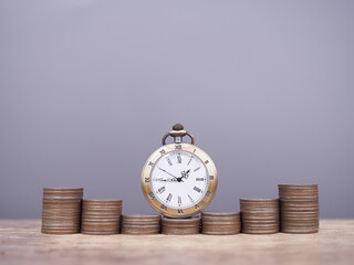 Vintage watch and stack of coins. The concept of saving money for manage time to success business.