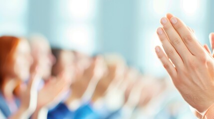 Hands clapping in a blurred background, symbolizing appreciation and support in a positive setting.