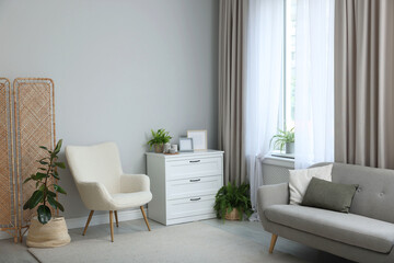 Stylish furniture and elegant curtains in living room. Interior design