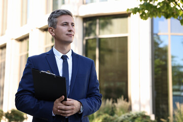 International relations. Diplomat with clipboard outdoors, space for text