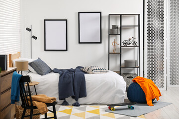 Teen's room interior with modern furniture and empty frames on wall