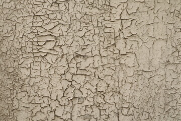 Textured surface with beige cracked paint