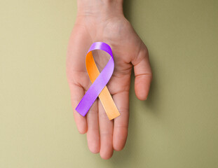 World Psoriasis Day. Woman with orange and orchid ribbon as symbol of support on olive color...