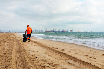  A dedicated beach cleaner starts the day early at El Saler Beach in Valencia, Spain. This...