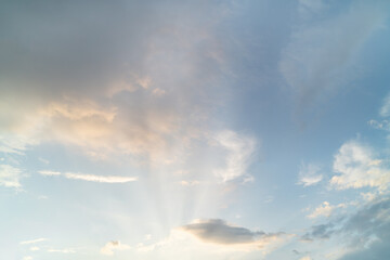 Beautiful summer morning sky with lighting clouds and sun rays. Copy space wallpaper.