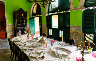 Antique tableware on a luxury and bourgeois table in a colonial house in Trinidad, Cuba