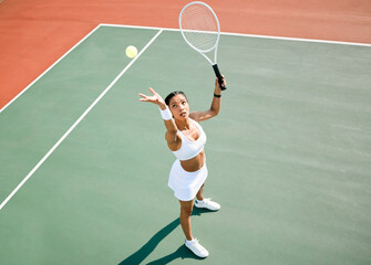 Serving, tennis player or woman in game for match, workout or sports exercise on outdoor court. Hobby, ball or above of girl athlete with racket ready for playing, fitness training or practice skills