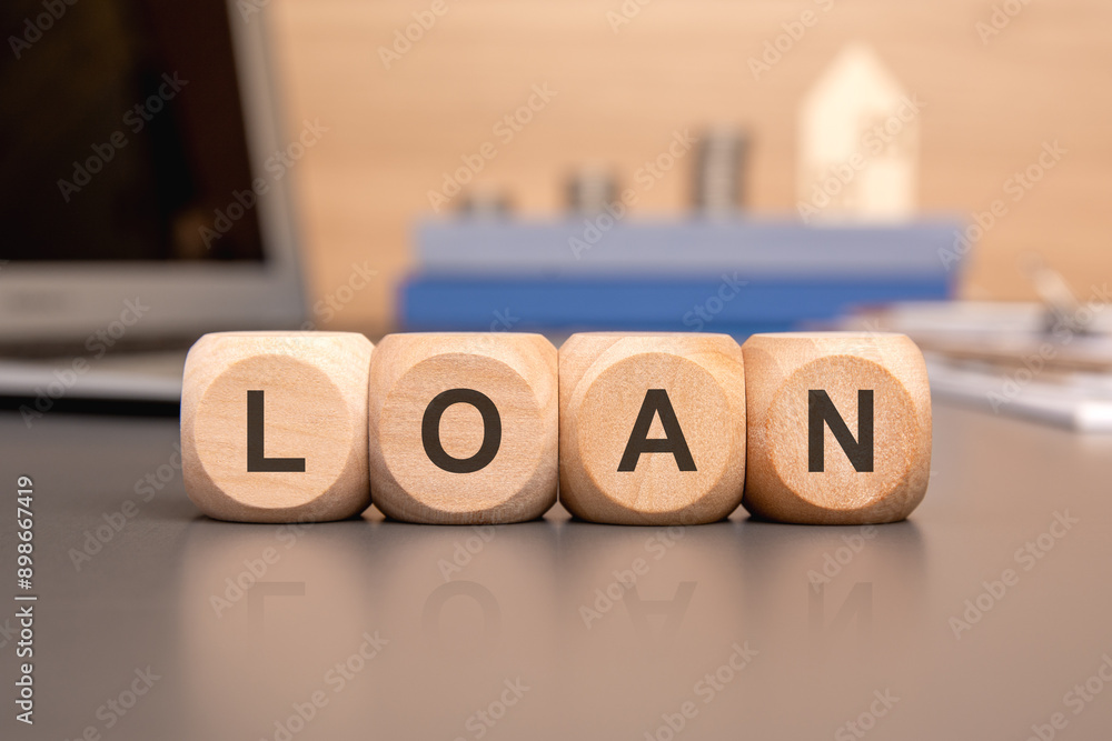 Poster a breaking loan concept demonstrated using wooden blocks on a desk within an office setting