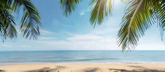 Fototapeta premium Tropical beach scene with palm tree border against the backdrop. Copy space image available.