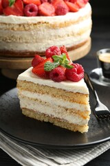 Tasty sponge cake with fresh berries and mint served on table, closeup