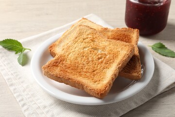 Delicious toasts served on wooden table, closeup