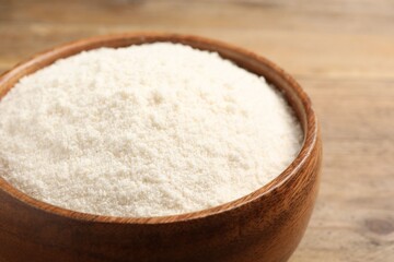 Coconut flour in bowl on table, closeup