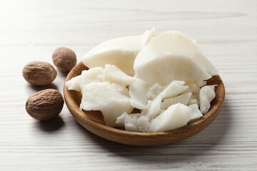 Natural shea butter and nuts on wooden table