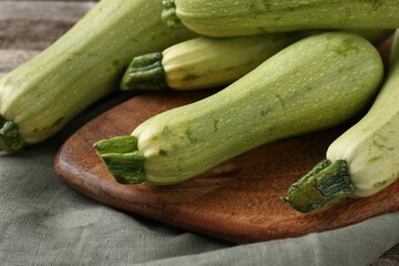 Raw ripe green zucchinis on table, closeup