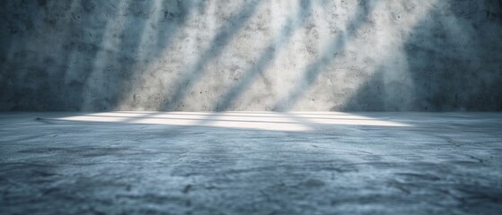  A room featuring a concrete floor and a single concrete wall with a beam of light penetrating its mid-section
