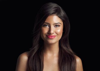 Obraz premium Portrait, hair care and woman with beauty, glow and shine on black studio background. Face, person and model with luxury, aesthetic or grooming routine with dermatology, keratin or salon treatment