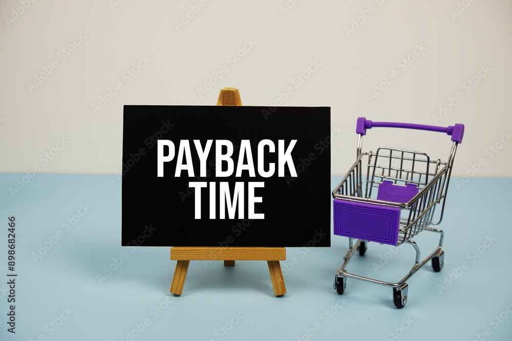 Poster payback time text message and trolley shopping cart on blue background