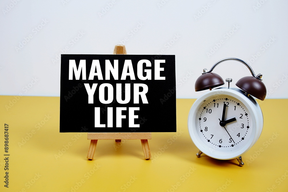 Poster manage your life text on paper card with alarm clock on yellow background