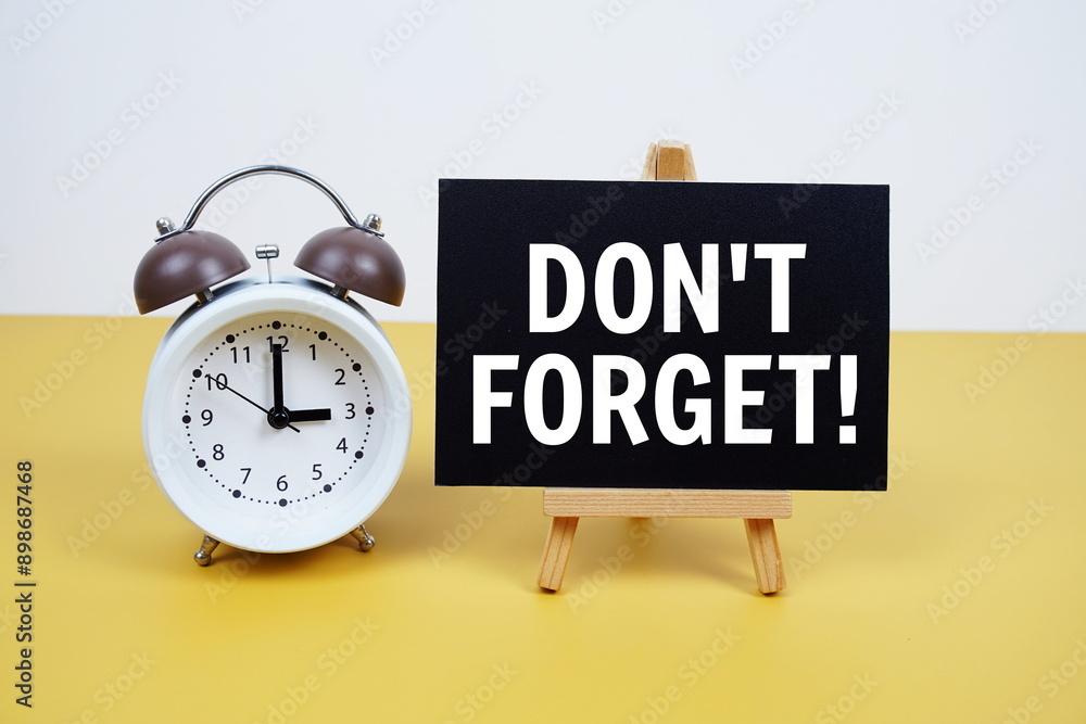 Poster don't forget text on paper card with alarm clock on yellow background