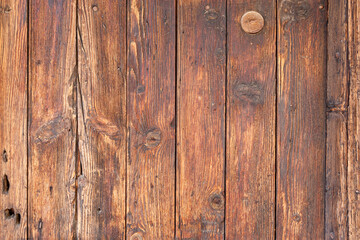Obraz premium Old weathered brown hardwood plank texture backgroundwith a few natural cracks and holes