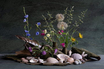 floral composition of wildflowers using sycamore bark and sea shells. naturalistic style.