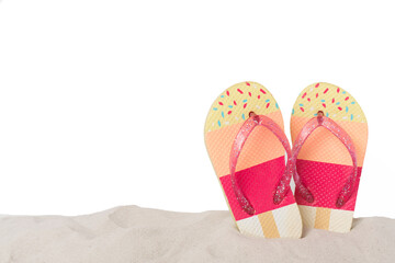 Flip flops on sand against isolated background