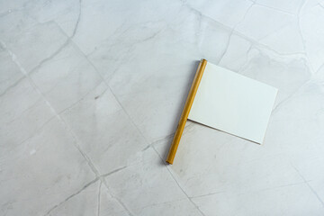 white empty neutral miniature flag with empty copyspace as note on white marble background