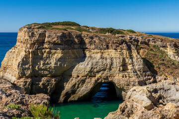 Coastline and Benegil Caves as seen from the Seven Hanging Valleys Trail, this trail encompasses the coastline between Marinha Beach and Vale Centeanes Beach, Lagoa municipality, Algarve, Portugal. © Catrina