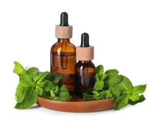 Bottles of essential oils and mint isolated on white