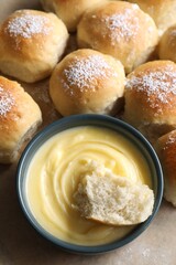 Delicious dough balls with sauce on table, closeup
