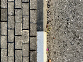 Top view of street layer texture consist of concrete pavement, black and white sidewalk border and asphalt road material