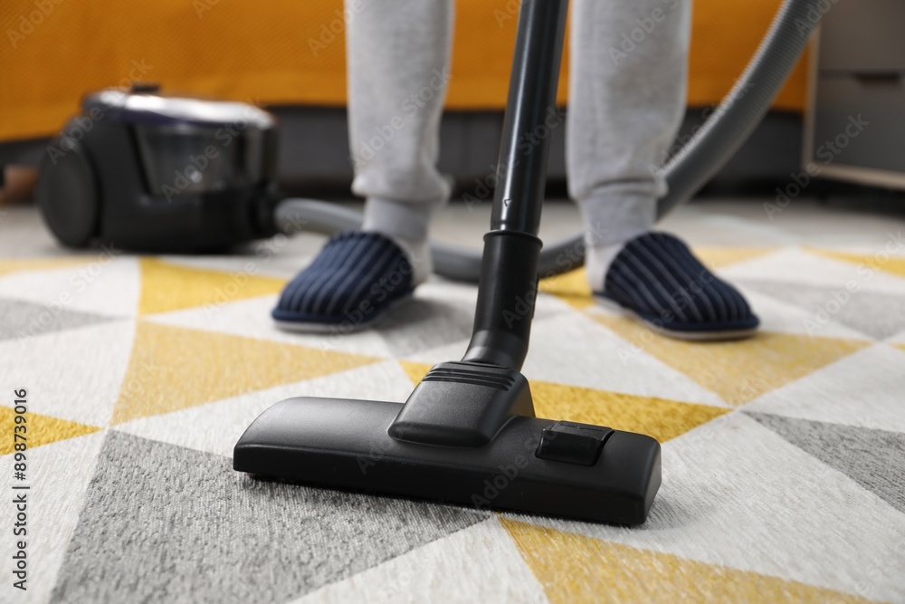 Canvas Prints Man with vacuum cleaning carpet indoors, closeup