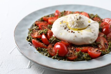 Fresh delicious burrata salad on white table, closeup